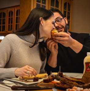 girl eating donair burger from guy